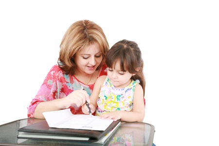 Mother and daughter doing homework at home の写真素材