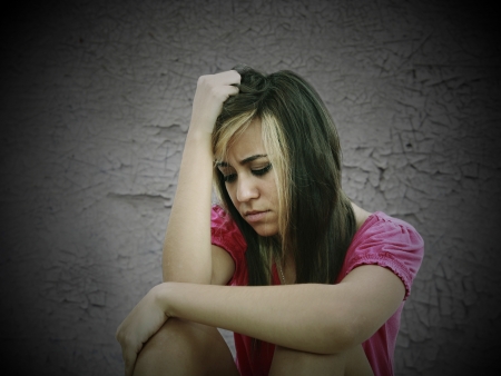 portrait of a sad teenage girl looking thoughtful about troubles の写真素材
