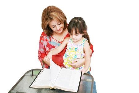 Minority woman and her daughter reading the Bible の写真素材