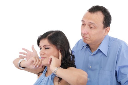 Portrait of a young woman gets earful from her husband against white background の写真素材