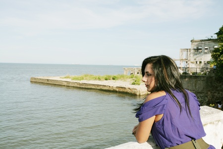 Beautiful caucasian woman looking out over sea の写真素材