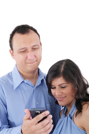 Couple looking at a cell phone and smiling isolated on a white background の写真素材