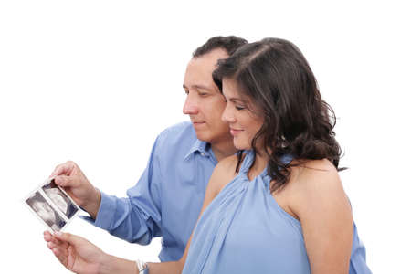 Pregnant couple looking at an ultrasound 
