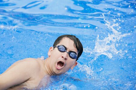 Swimmer breathing performing the crawl stroke の写真素材