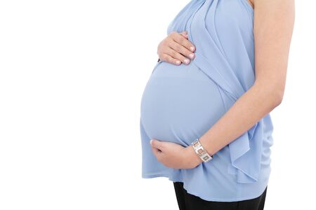Image of pregnant woman touching her belly with hands isolated on white background の写真素材