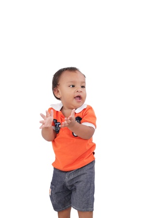 Happy one year old baby boy walking on white background の写真素材