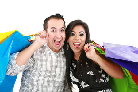 Beautiful young couple with shopping bags. Isolated on white の写真素材