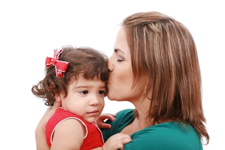 Happy mother kissing her daughter, isolated on white background の写真素材