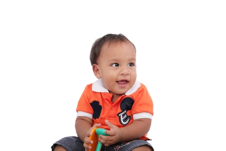 Adorable one year old child playing and having a good time, isolated on white の写真素材