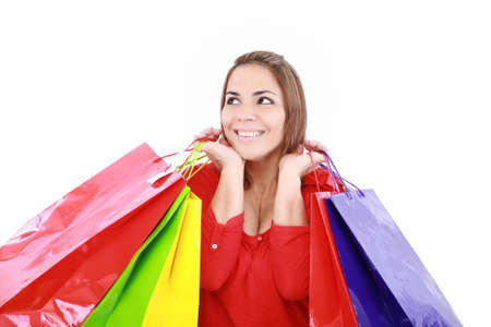 Shopping woman holding shopping bags looking up to the side on white background at copy space.の写真素材
