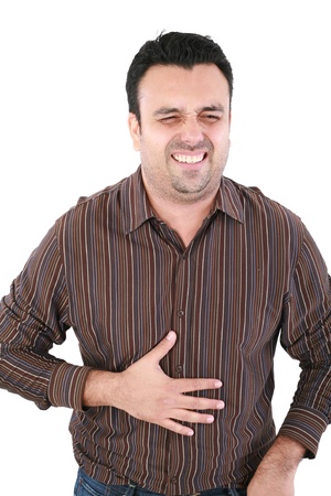 Young man suffering from a bad stomach ache pain isolated on white background の写真素材