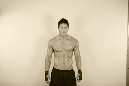 vintage image of muscle man posing in gymの写真素材