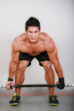 Young man lifting the barbell in the gym. の写真素材