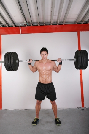 Man with dumbbell weight training equipment on sport gymの写真素材