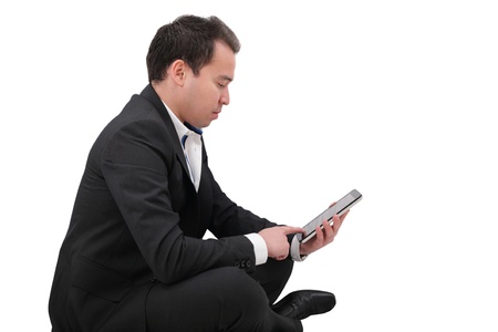businessman with digital pad touch screen sitting in yoga lotus pose on floor isolated over white background の写真素材