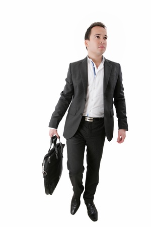 Portrait of a business man carrying a suitcase on white background の写真素材