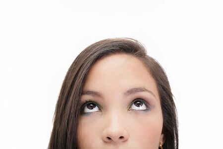 Closeup portrait of a beautiful young woman looking up, isolated on white background