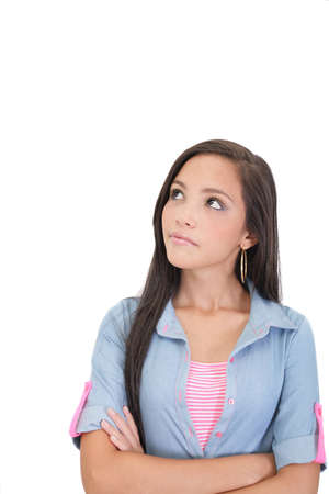 Thoughtful and worried woman looking up, isolated over a white background の写真素材