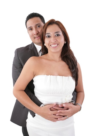 Happy young man hugging his girlfriend isolated on white background.  Focus in the woman.の写真素材