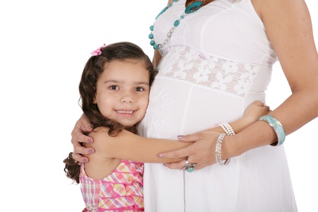 Beautiful pregnant woman with her daughter. Isolated on white background の写真素材