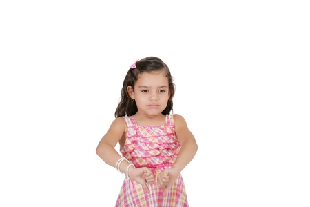 portrait of a beautiful little girl with thumb down isolated on white backgroundの写真素材