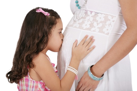 Beautiful pregnant woman with her daughter. Isolated on white background の写真素材