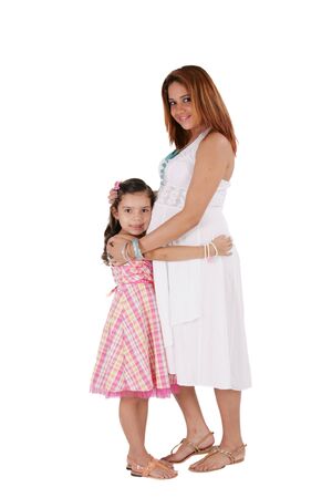 Happy young pregnant woman with little daughter. Focus in the girl.の写真素材