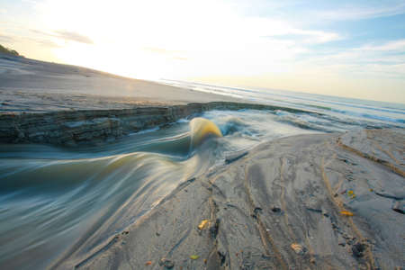 sand beach and lake in the sunriseの写真素材