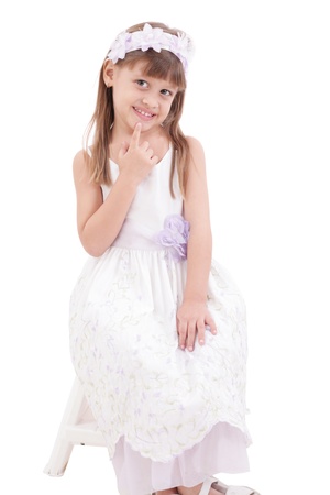 A portrait of a cheerful little girl on the white background の写真素材
