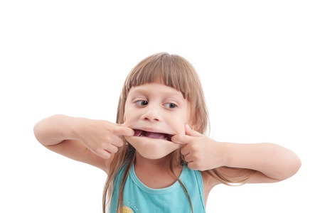 Little girl making a strange face on white backgroundの写真素材