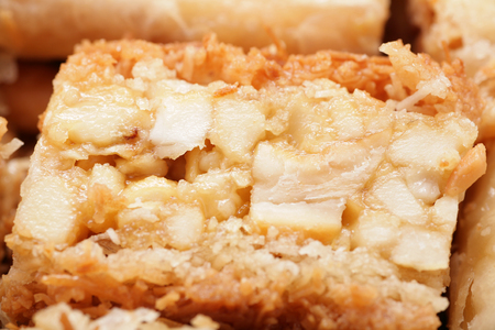 Macro shot of a delicious arabic desert baklava.  Is made of filo pastry filled with nuts and steeped in Attar syrup (orange or rose water or sugar) or honey. It is usually cut into triangular or diamond shapes.の写真素材