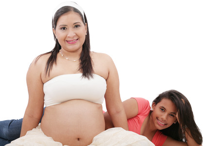 Beautiful pregnant woman with her daughter.の写真素材