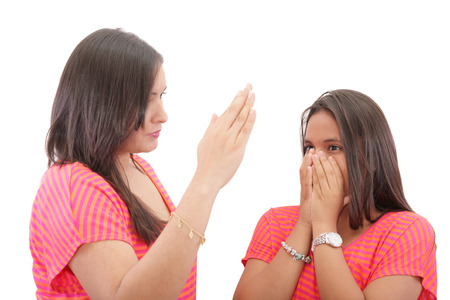 mother preparing to slap her daughter in the faceの写真素材