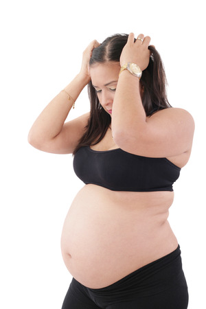 A young pregnant woman is experiencing the discomfort of pregnancy の写真素材