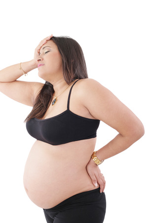 Pregnant woman standing with headacheの写真素材
