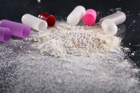 Macro shot of powder by open pillsの写真素材