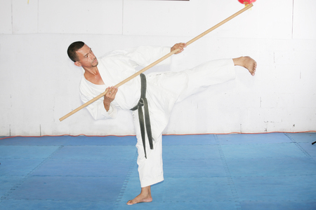 Man in shotokan karate with a bo in his handsの写真素材