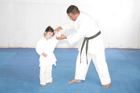 Black belt Karate teaching a little girlの写真素材
