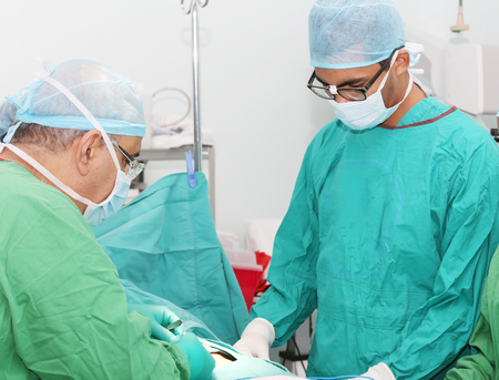 Surgeons working in operation roomの写真素材
