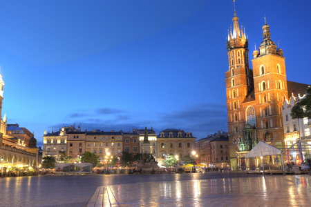 KRAKOW, POLAND - JUL 3: View of Main Market Square (Kosciol Mariacki) in sunset on Jul 3, 2017 in Krakow, Poland. Is one of the largest medieval town squares in Europe.のeditorial素材