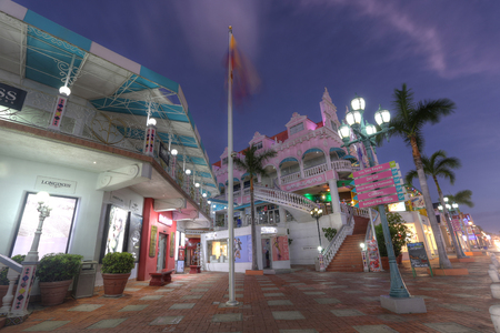 ORANJESTAD, ARUBA - FEB 6: Lloyd G. Smith Boulevard in Oranjestad, Aruba, in Feb 6, 2018. This is the main highlight in the city because of its Dutch Colonial architecture in the sunset.のeditorial素材