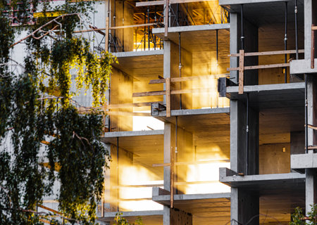 Rays of sunlight breaks through the glowing floors of a high-rise apartment building. Modern...