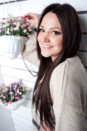 The young girl is engaged in flowers, decorative potの写真素材