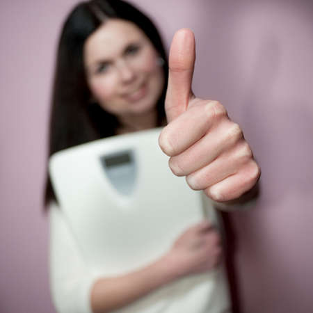 Close-up of woman with Close-up of woman with thumbs-up signの写真素材