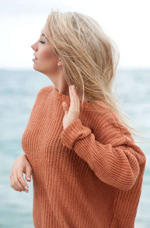 A beautiful caucasian girl outdoor on the beach during summer