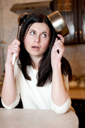 Young woman thinking about a recipe on kitchenの写真素材