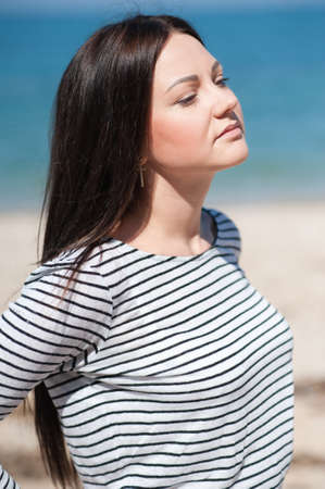 young woman enjoying the beach on a sunny summer dayの写真素材