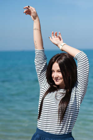 young woman enjoying the beach on a sunny summer day