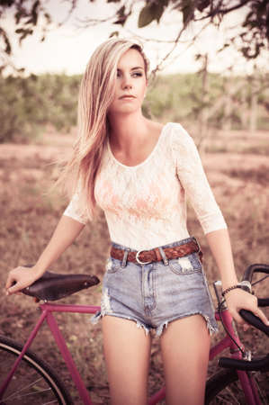 Young pretty blonde woman posing  in summer sunshine. Fashion portrait.の写真素材