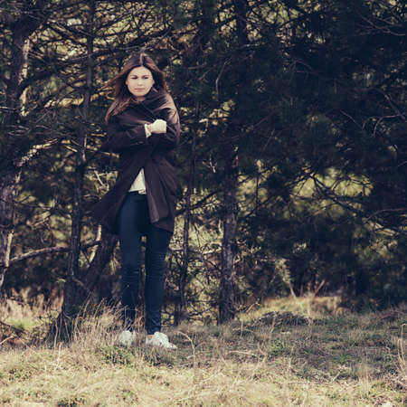 Fashion woman outdoor portrait. Beautiful girl posing on the street in coat.の写真素材